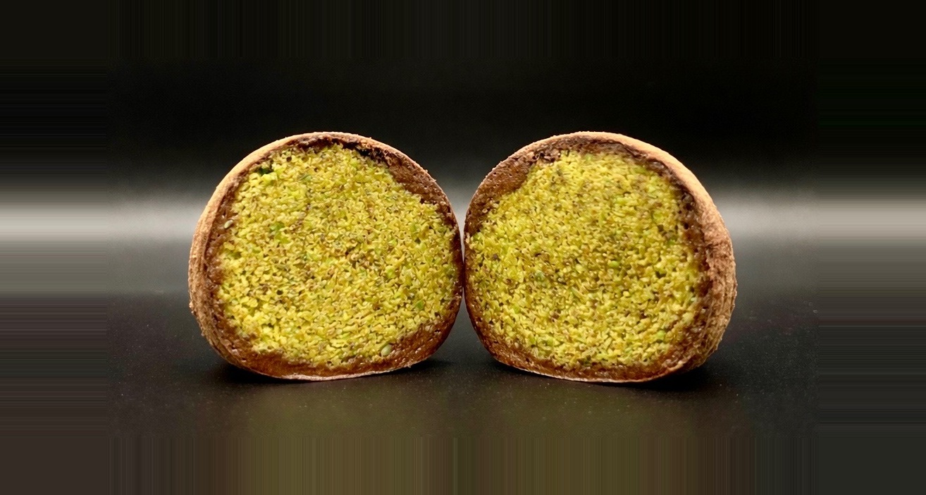 Sweet Snow Dubai chewy cookie, halved to show the pistachio filling